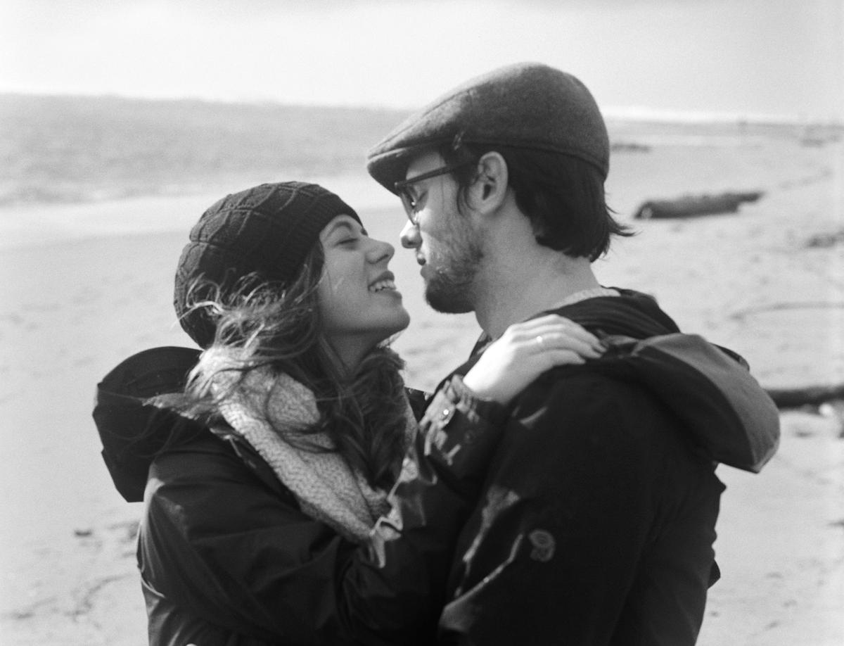 lovers james and melissa at the beach in black and white