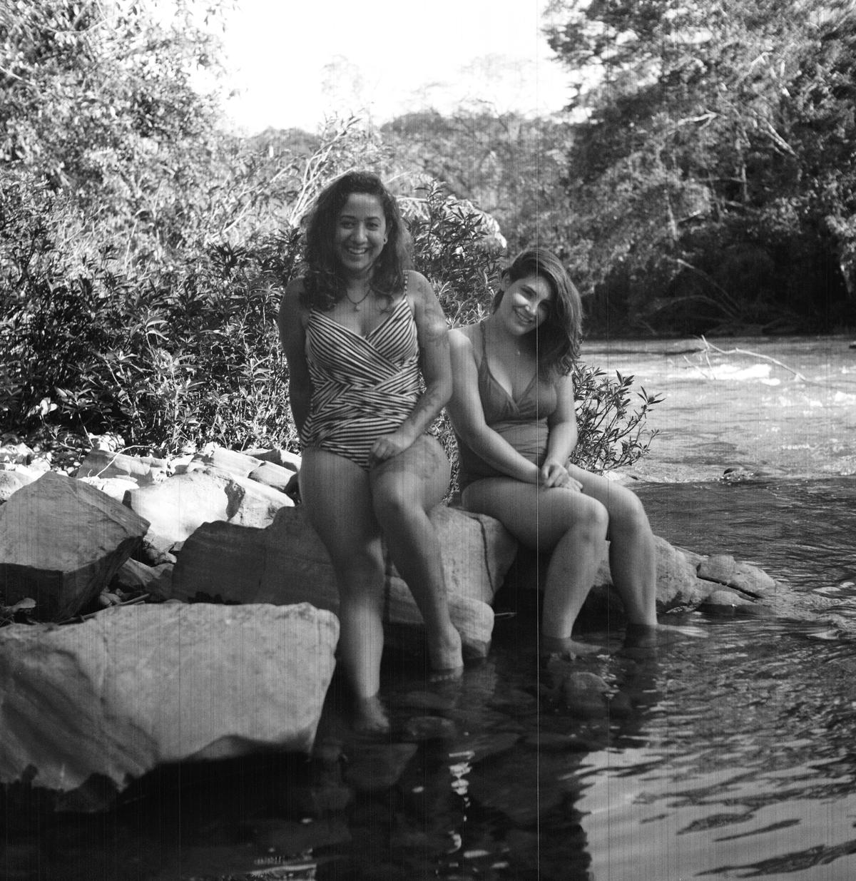 Two women near a river in black and white photo