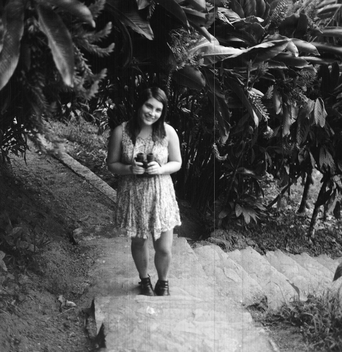 Woman in jungle holding binoculars
